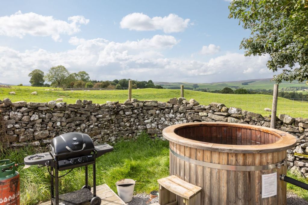 A hot tub and BBQ overlooking a sheep field in the Yorkshire Dales. 