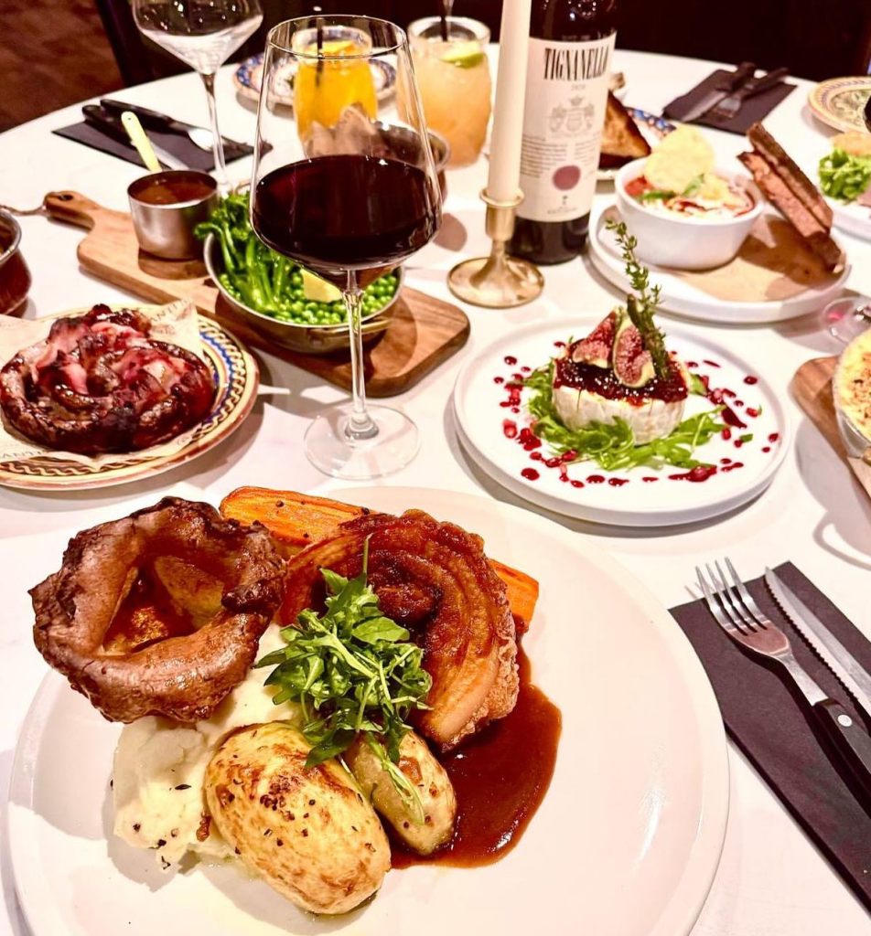 A shot of the table with Sunday roast and wine at Santi's Italian in Hull. 