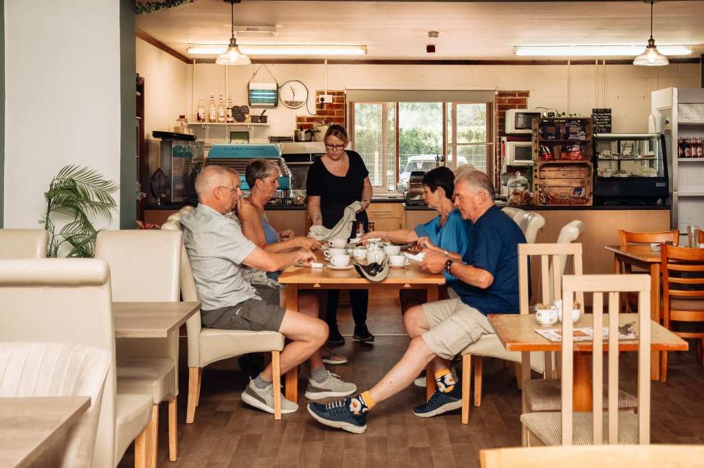 Inside the Mile Farm Shop in Pocklington. A table of friends are being served food in the cafe. 