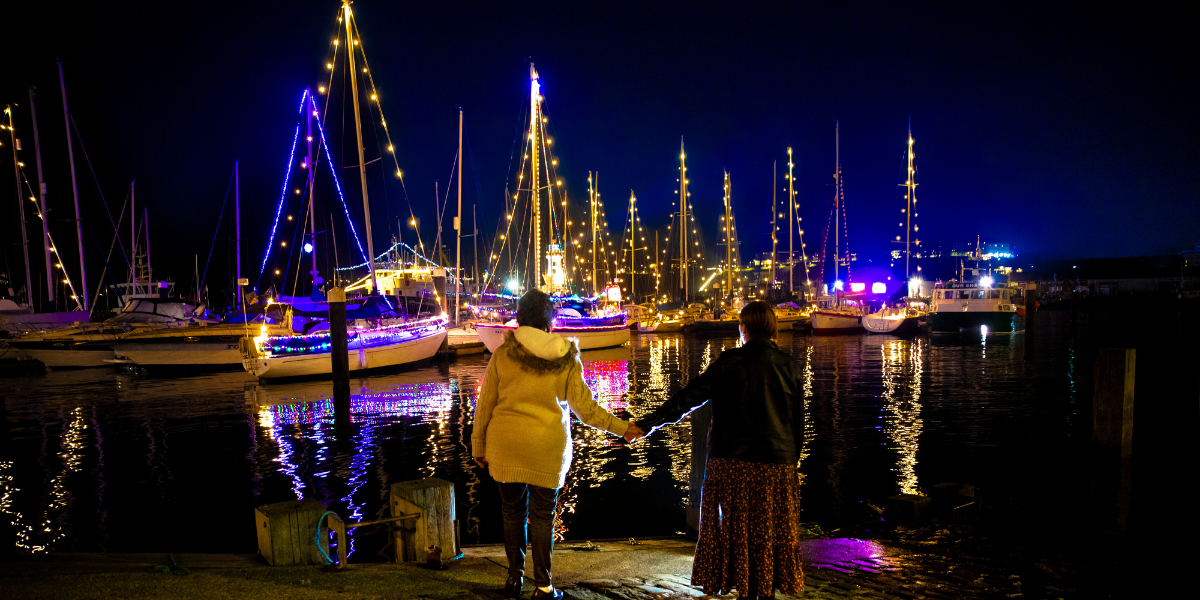 Boats lit up with festive lighting in Scarborough. 