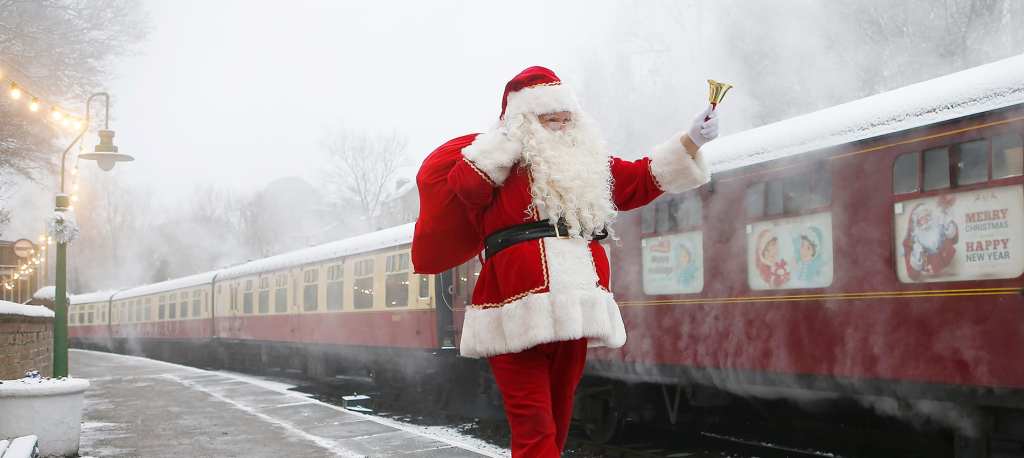 Santa on a train platform next to the North York Moors Railway. 