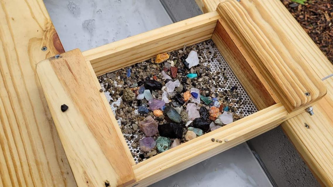 Gems revealed in a pan at the gem panning experience, Stump Cross Caverns. 