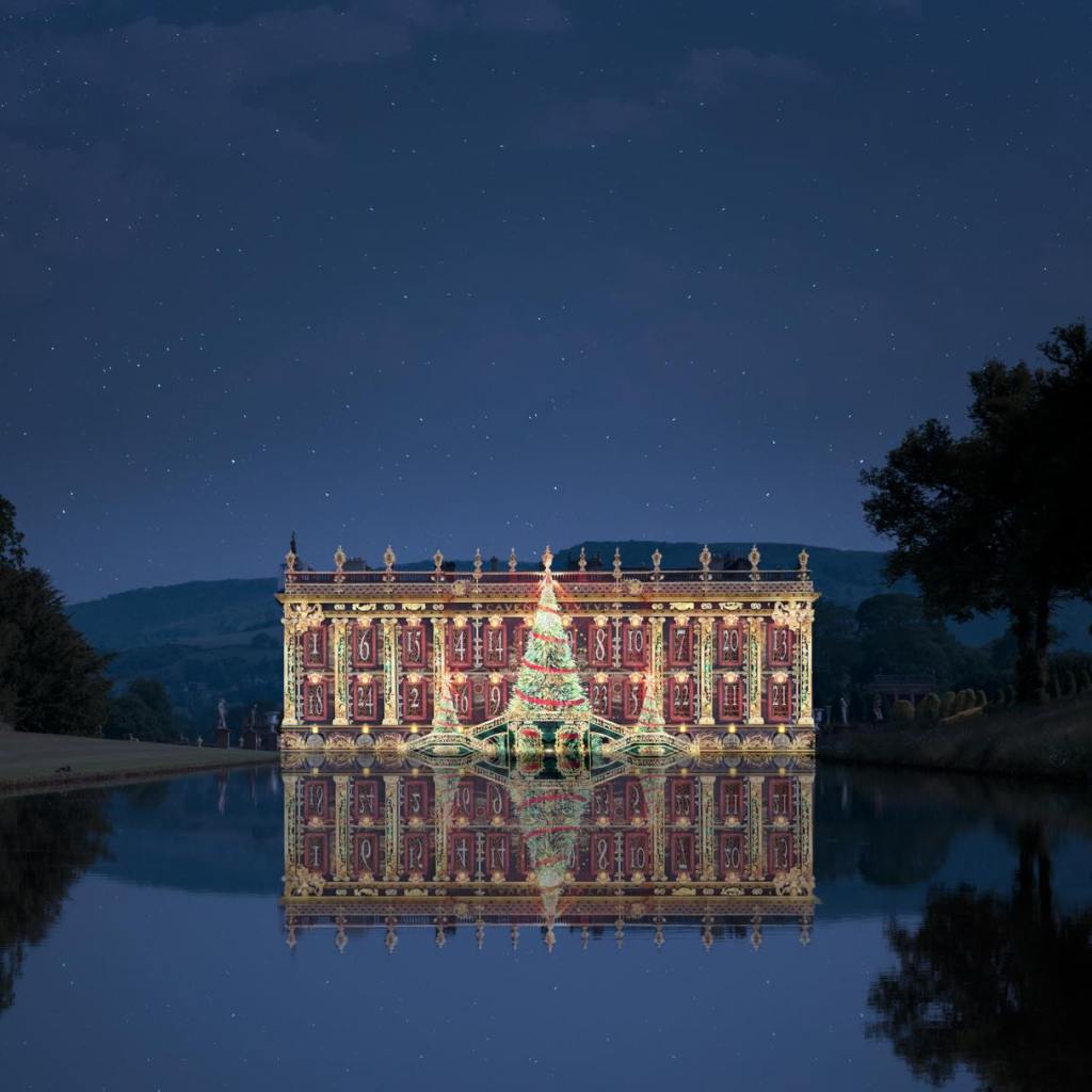 The exterior of Chatsworth House as seen from over the lake, with a festive advent calendar light display encompassing the house. 