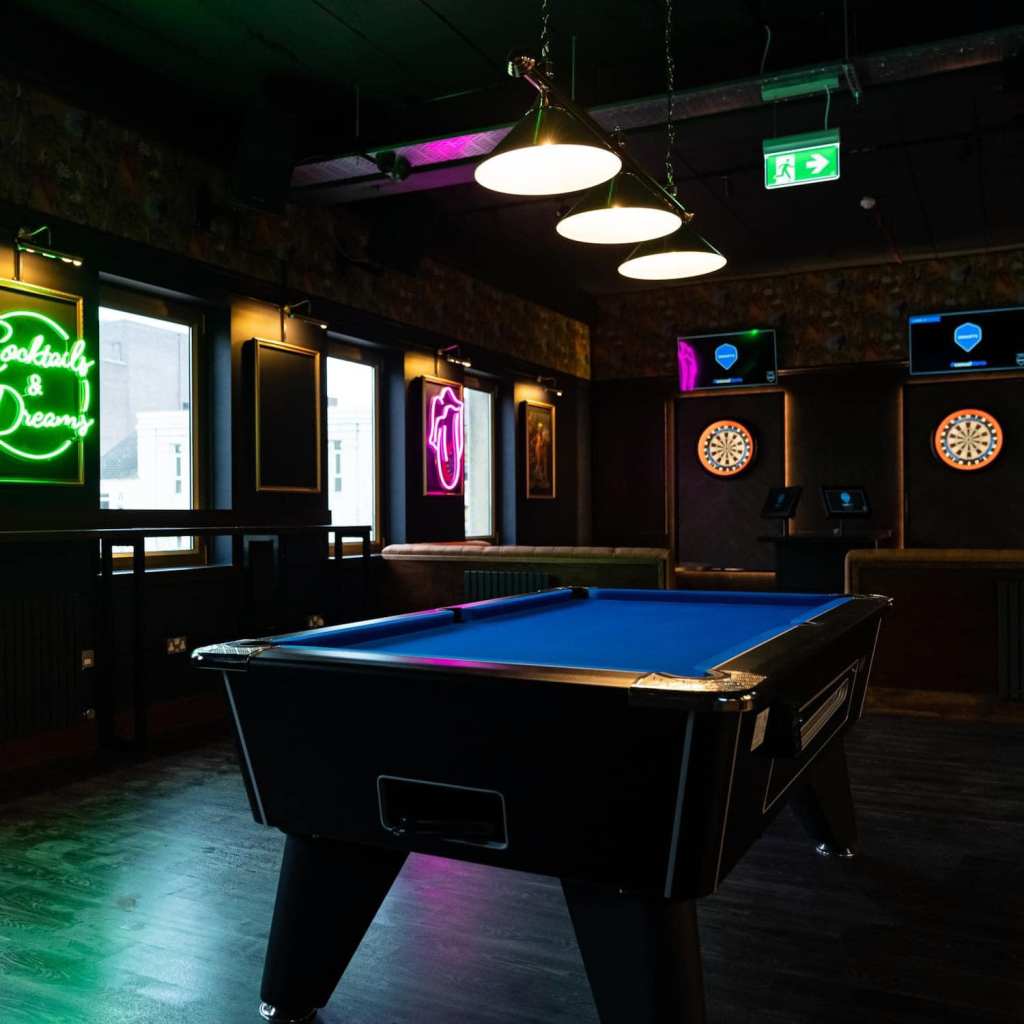 Inside The Works Barnsley, a pool table with VR darts in the background. 