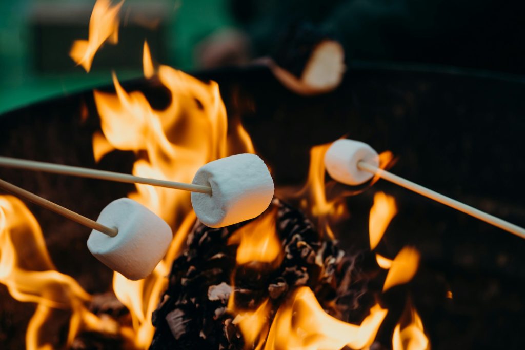 Marshmallows being roasted on an open fire. 