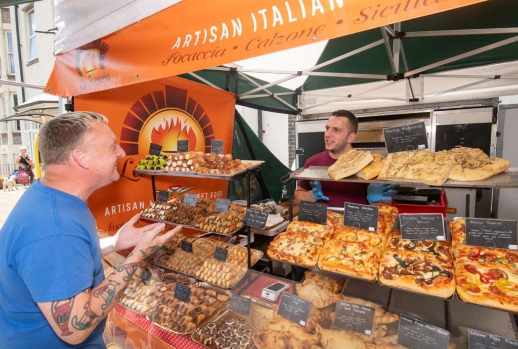 A guest browsing fresh bakes at a food festival. 