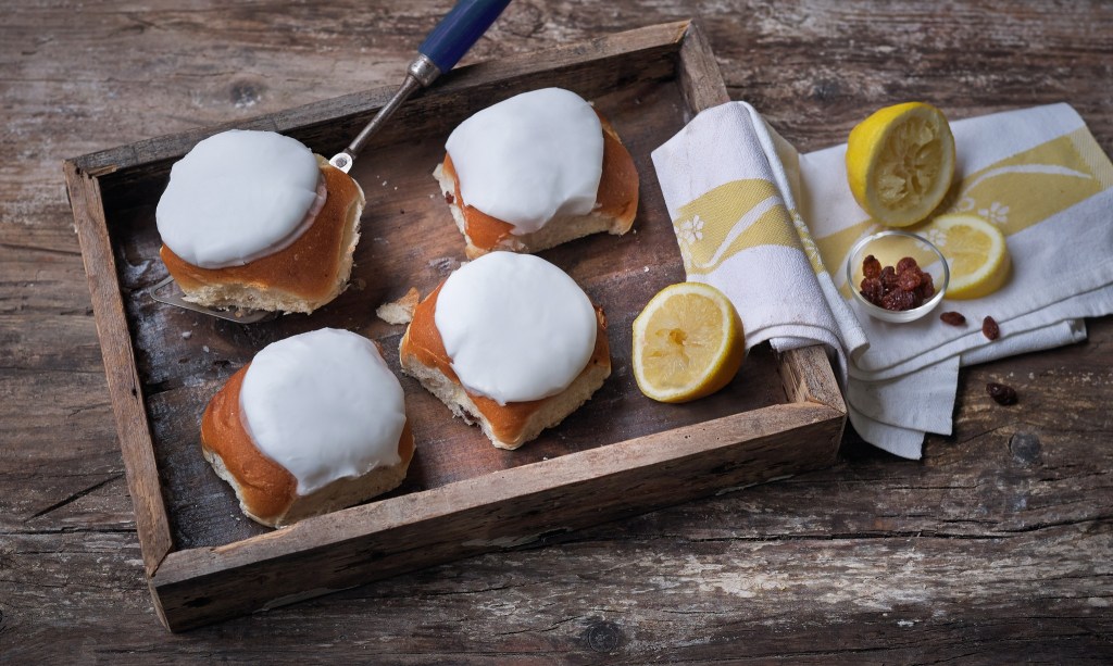 Botham's of Whitby famous lemon buns served on a wooden platter. 